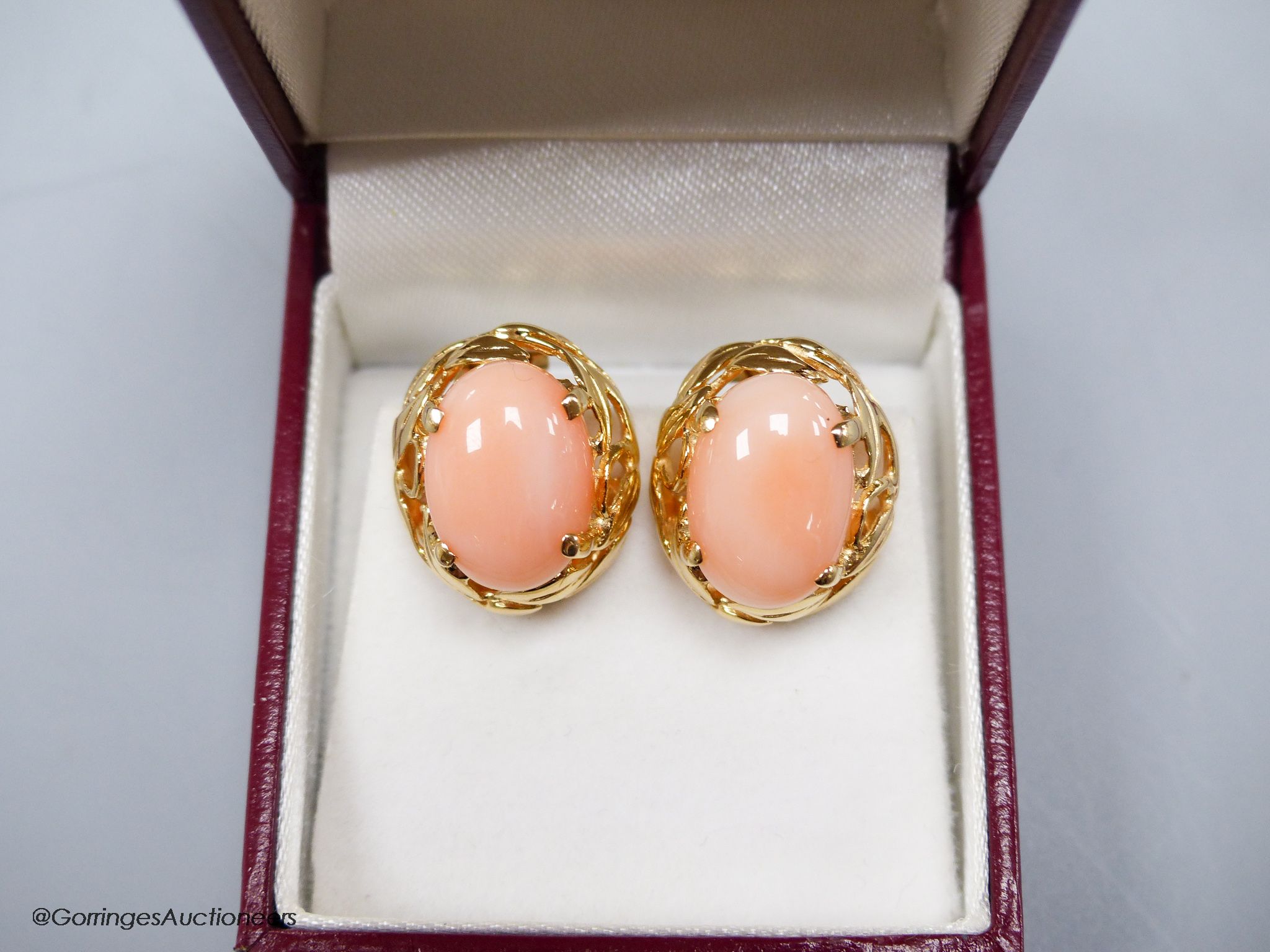 A modern pair of yellow metal (stamped 14k) and oval coral bead earrings, 16mm